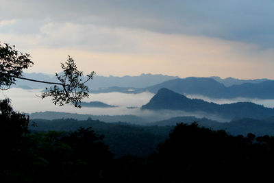 Scenic view of silhouette mountains against sky