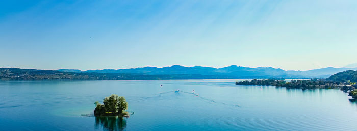 Scenic view of lake against clear blue sky