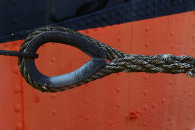 Close-up of rope tied on metal wall