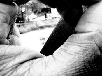 Cropped image of hand holding outdoors