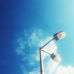 Low angle view of lamp post against blue sky