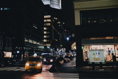 Illuminated city street at night