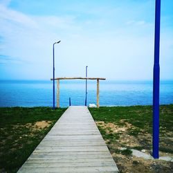 Pier over sea against sky