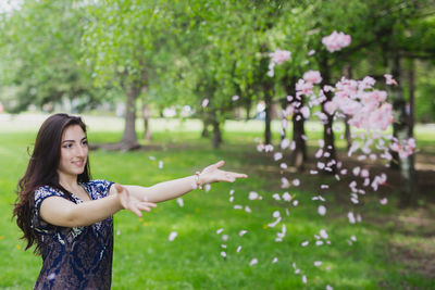 Young woman standing on tree