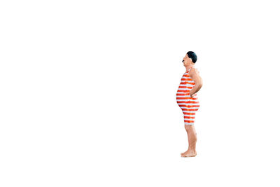 Rear view of young woman standing against white background