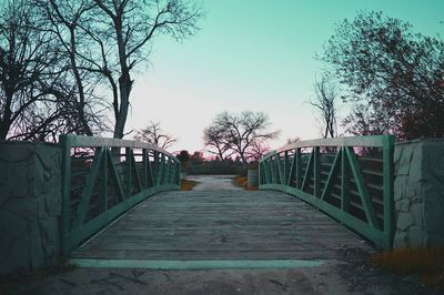 Footbridge passing through bare trees