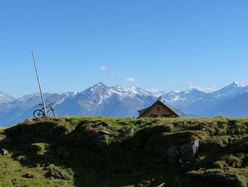 Scenic view of snowcapped mountains against clear blue sky