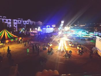 People at illuminated street lights at night