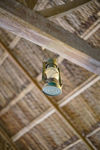 Low angle view of electric lamp hanging on ceiling