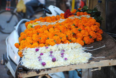 Close-up of orange and white flower in market for sale