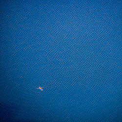 Aerial view of man swimming in sea