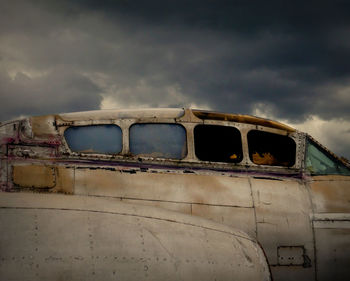 Abandoned airplane against sky