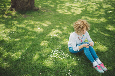 High angle view of woman sitting on grass