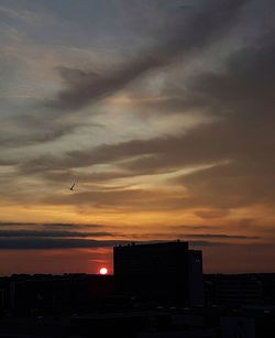 Silhouette of built structure at sunset