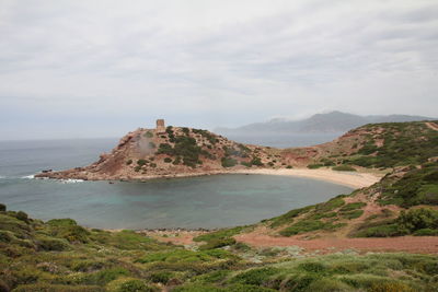 Scenic view of sea and mountains against sky