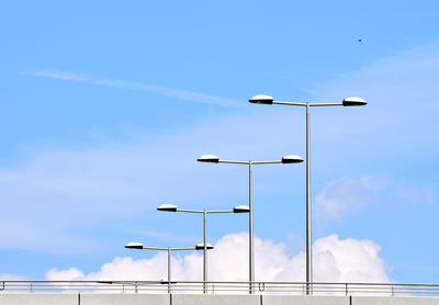 Low angle view of street lights against sky