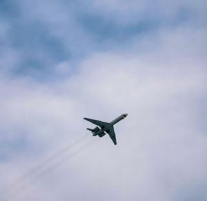 Low angle view of airplane flying in sky