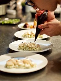 Close-up of hand holding food in plate