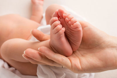 Low section of baby feet