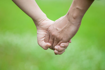 Close-up of person hand holding blurred outdoors