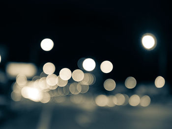 Defocused image of illuminated street lights at night