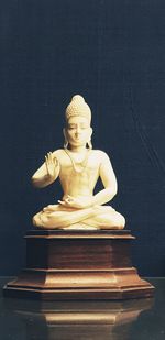 Close-up of buddha statue on table