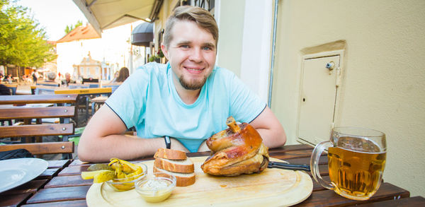 Portrait of a smiling young man having food