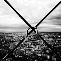 Sign board against cloudy sky