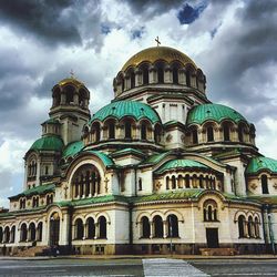 Low angle view of church against cloudy sky