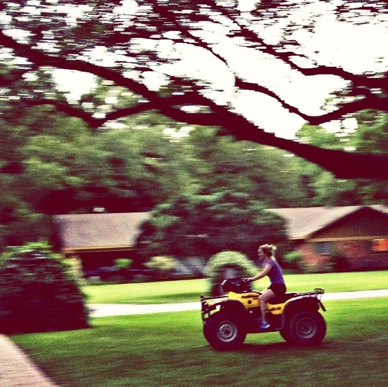 lifestyles, leisure activity, full length, grass, sitting, tree, casual clothing, land vehicle, park - man made space, side view, bicycle, young adult, men, mode of transport, riding, sunlight, day, childhood