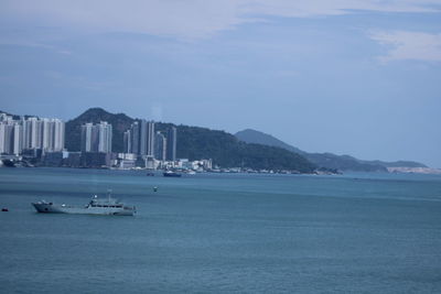 Scenic view of sea against sky in city