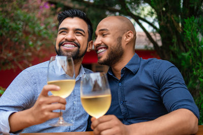 Portrait of smiling friends toasting wineglasses