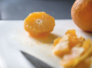 Close-up of cropped oranges on table