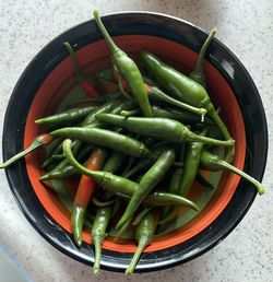 Directly above shot of green chili peppers in container