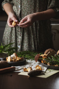 Midsection of woman having food on table