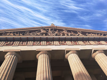 Low angle view of historical building against cloudy sky