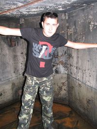 Portrait of young man standing against wall
