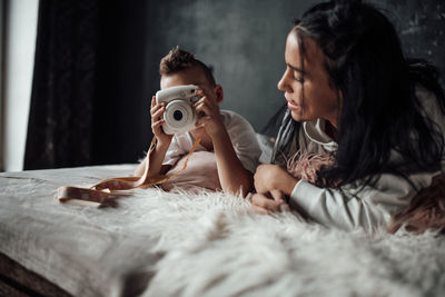 Woman lying on bed at home