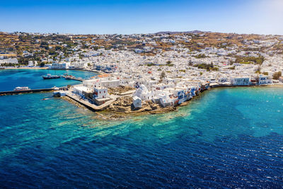 High angle view of sea and cityscape against sky