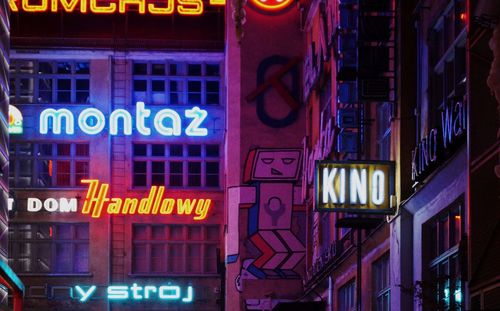 Illuminated neon sign in city