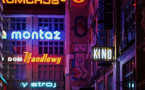 Illuminated neon sign in city