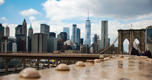 Modern buildings in city against cloudy sky