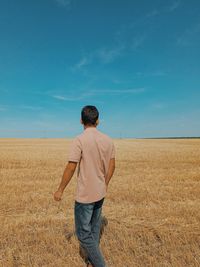 Rear view of man standing on field