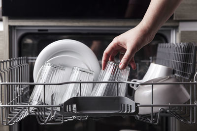 Cropped hand of man working in kitchen