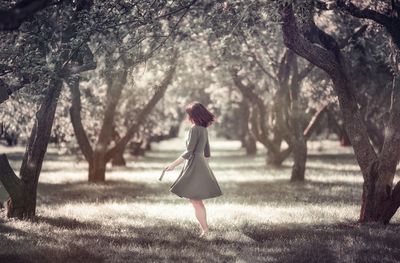 Side view of woman walking on field