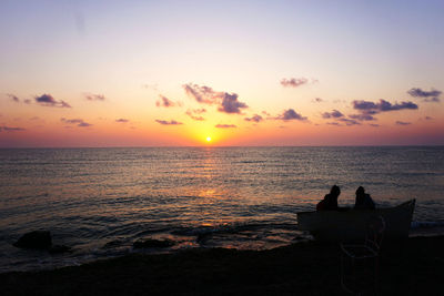 Scenic view of sea against orange sky