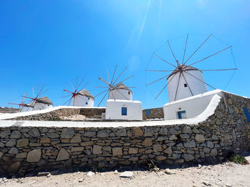 Low angle view of built structures against clear blue sky
