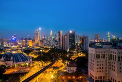 High angle view of city lit up at night