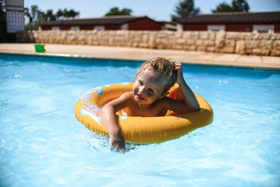 Boy swimming in pool