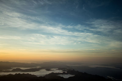 Scenic view of silhouette mountains against sky at sunset